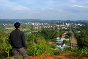 Góc nhìn toàn cảnh một khu vực đô thị và nông thôn tại Đắk Nông với người dân quan sát sự thay đổi không gian xung quanh từ điểm nhìn cao, thể hiện nhu cầu cập nhật thông tin đất đ
